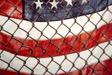 American Flag Behind Chain-Link Fence