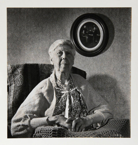 Maine 9 - Portrait of Woman with Family Portrait Black and White | Kosti Ruohomaa,{{product.type}}